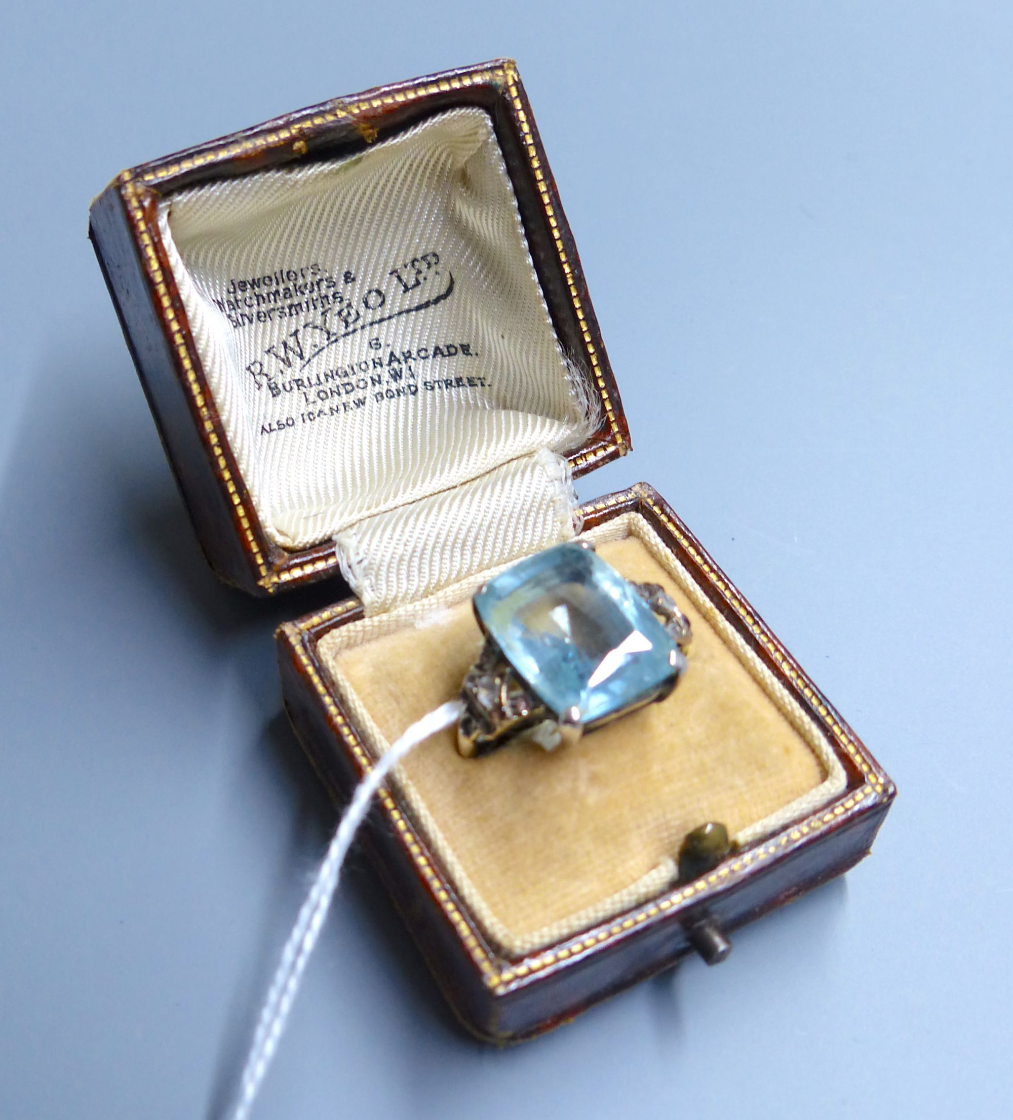 An early 20th century yellow metal, aquamarine and white stone chip set dress ring, size J, gross 5.2 grams.
